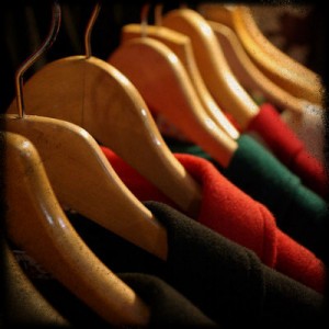 A series of clothes hanging on wooden hangers