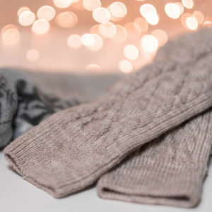 Beige woolen socks with bokeh effect in the background